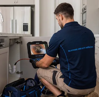 Clearing a blocked sink at a Elizabeth Bay property